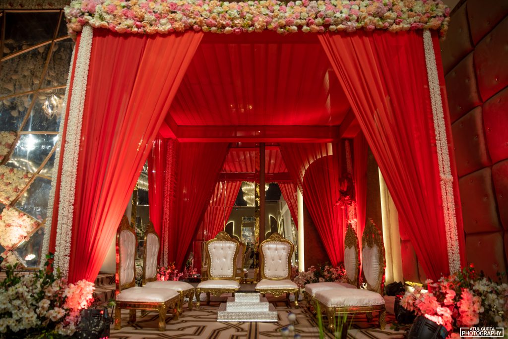 Red floral mandap in the banquet hall