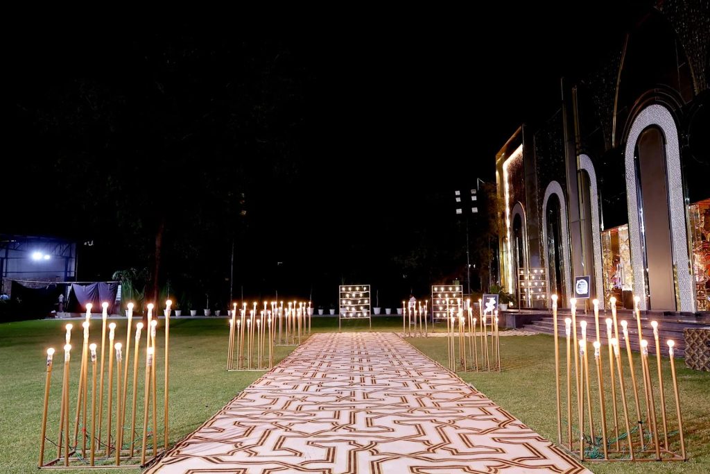 Candle-lit aisle on the lawn at night