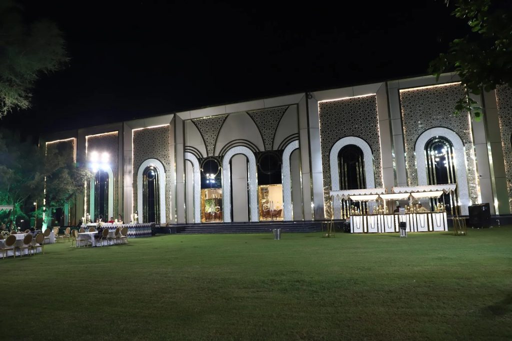 The lawn and fort-inspired façade at night